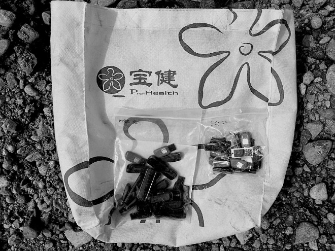 USB drives filled with foreign content and ready to be taken across the border in a plastic bag, lying on the bank of the Tumen River.